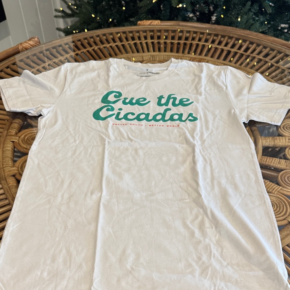“Cue the Cicadas” Bitter Southerner White T-Shirt with Green and Orange Text